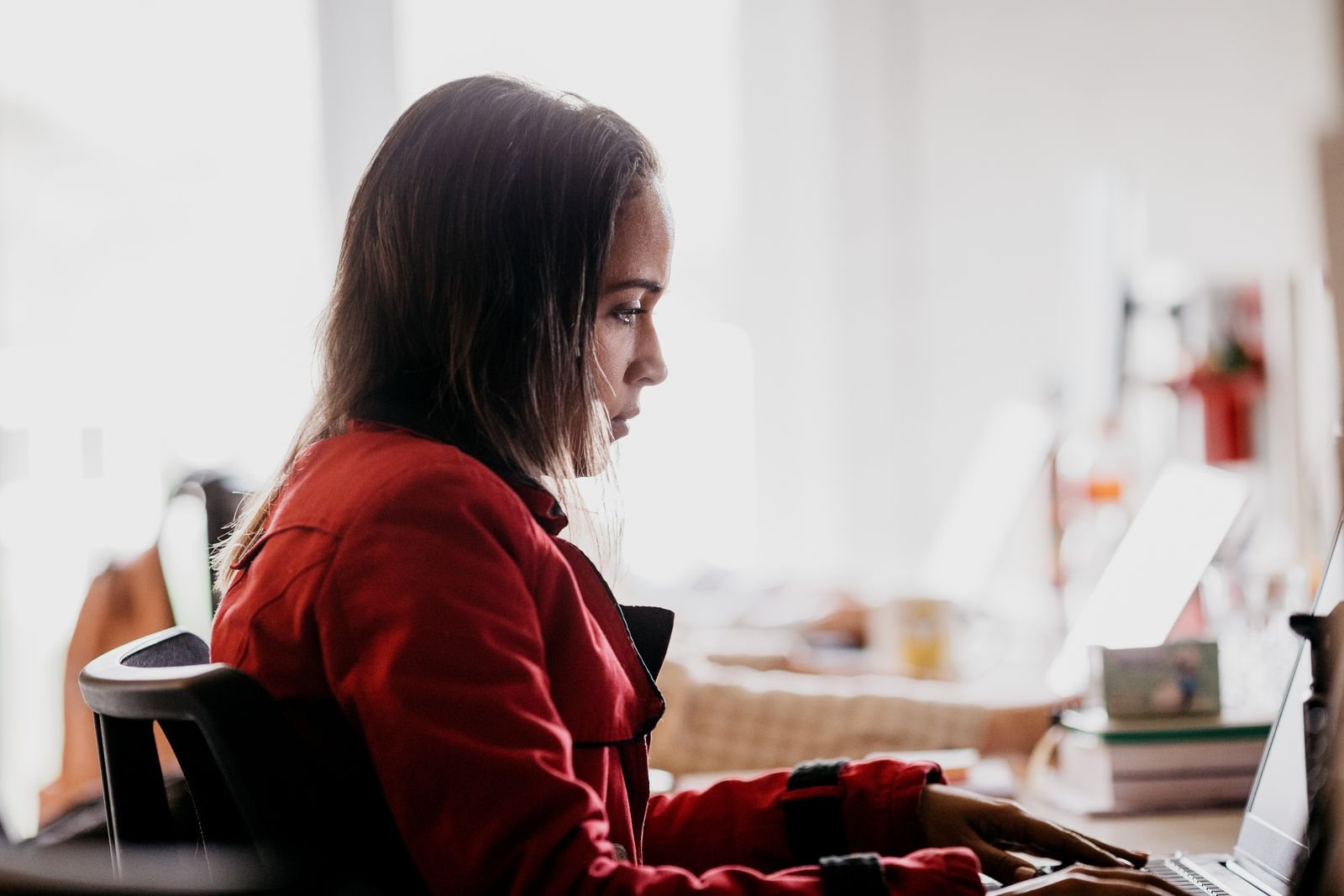 Home Consultant working at a desk with a laptop and monitor