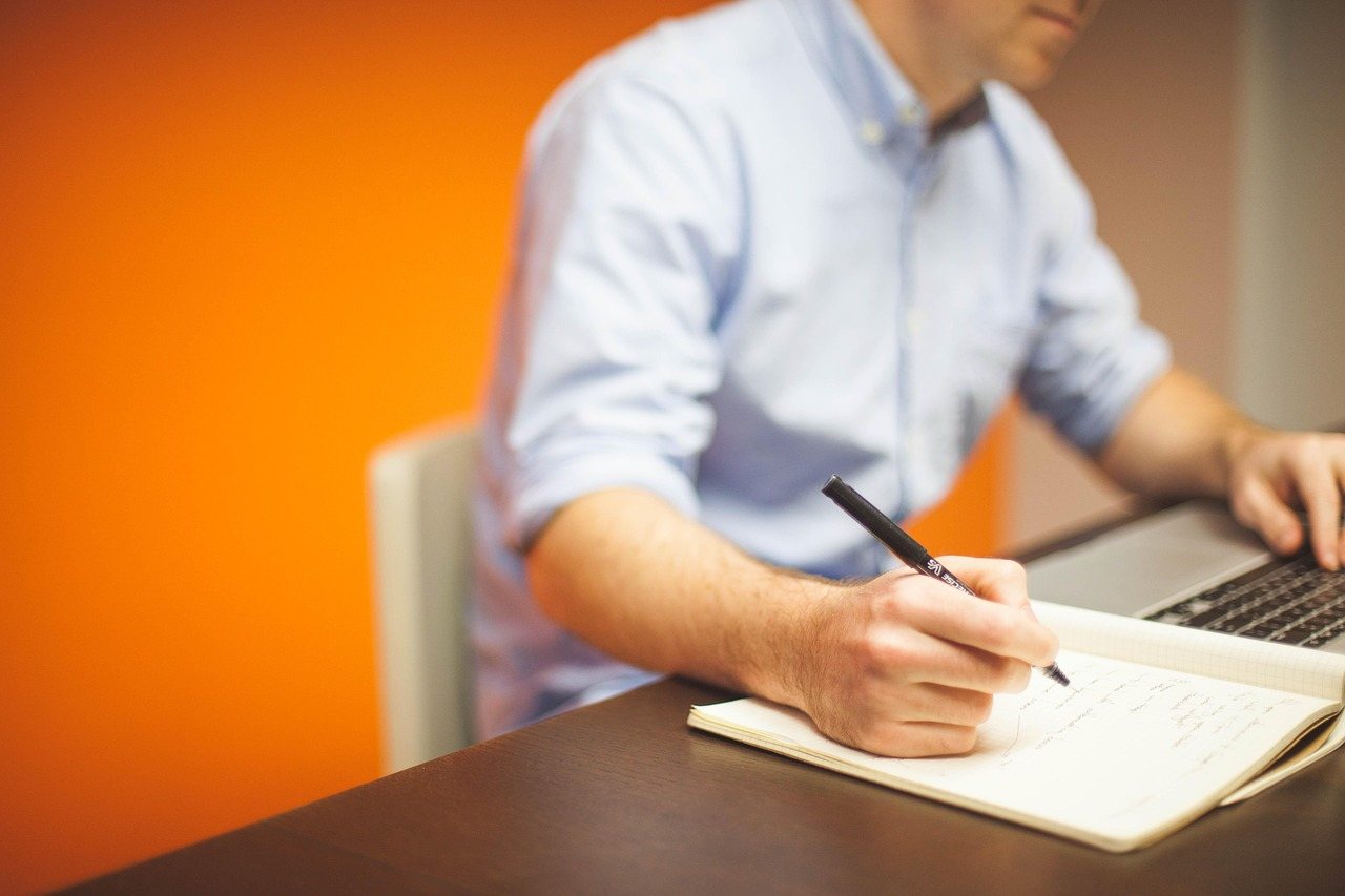 About Adviser writing notes at a desk