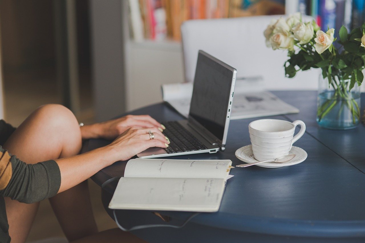 Home Person working remotely with a laptop and coffee