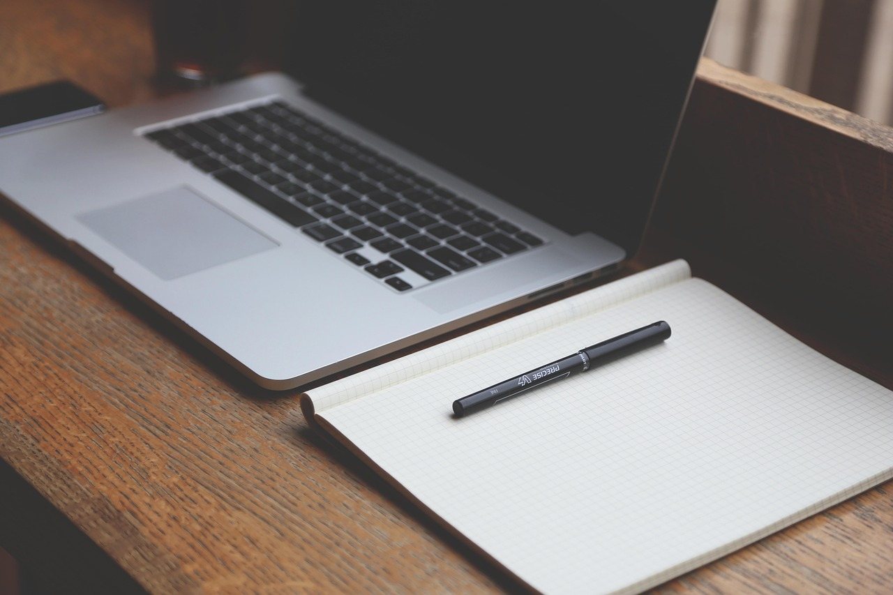 Home Notebook and laptop on a wooden desk