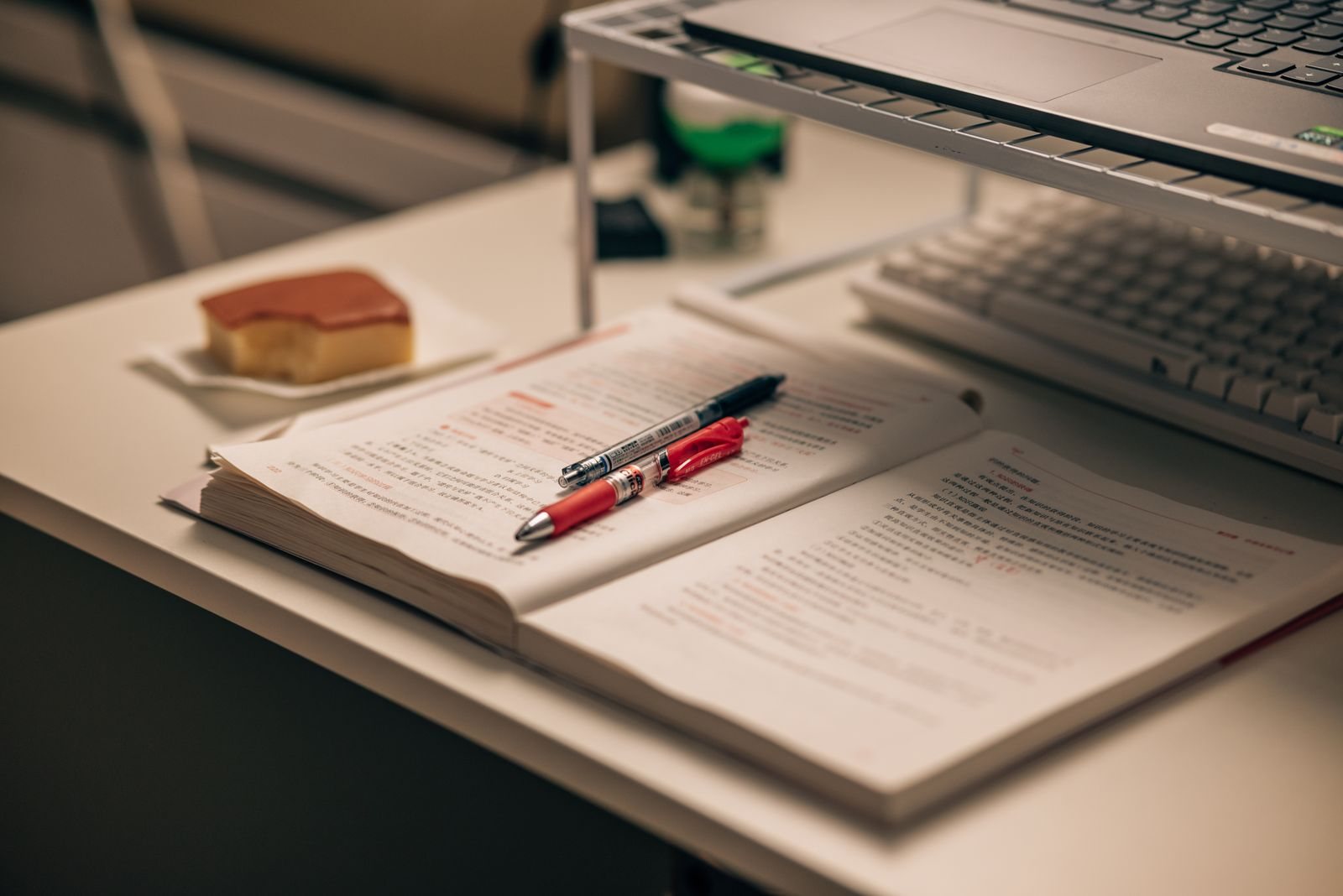 Contact Notebook, pen and printed documents laid out on a desk